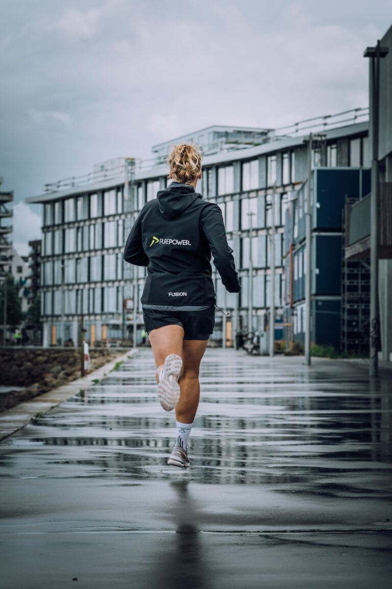 woman in black jacket running on water